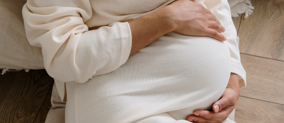 a mother is holding her baby bump